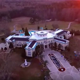 The Up And Down History Of Evander Holyfield's Unbelievable Former Mansion (Current Owner: Rick Ross)