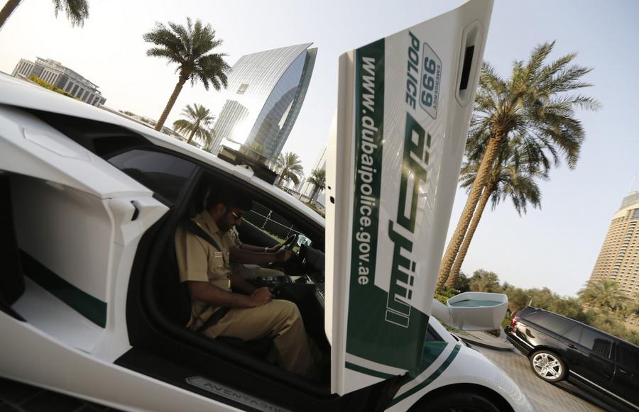 Emirati policemen patrol in an especially modified Lamborghini Aventador on April 16, 2013 in the Gulf emirate of Dubai. The introduction of the sports car, which can reach speeds of up to 349 km/h (217 mph), aims to make justice quicker on Dubai's dangerous highways. AFP PHOTO/KARIM SAHIB (Photo credit should read KARIM SAHIB/AFP/Getty Images)
