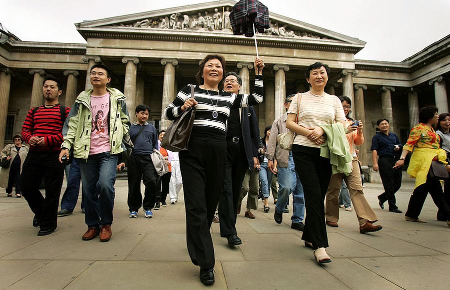 LONDON - JULY 25: Chinese tourists visit the British Museum on July 25, 2005 in London. In 2004, 135,000 Chinese citizens traveled to the UK but were only allowed to do so for business or study reasons or to visit family. Today saw the arrival of the first 80 Chinese tourists who flew into London Heathrow on a package tour. (Photo by Bruno Vincent/Getty Images)