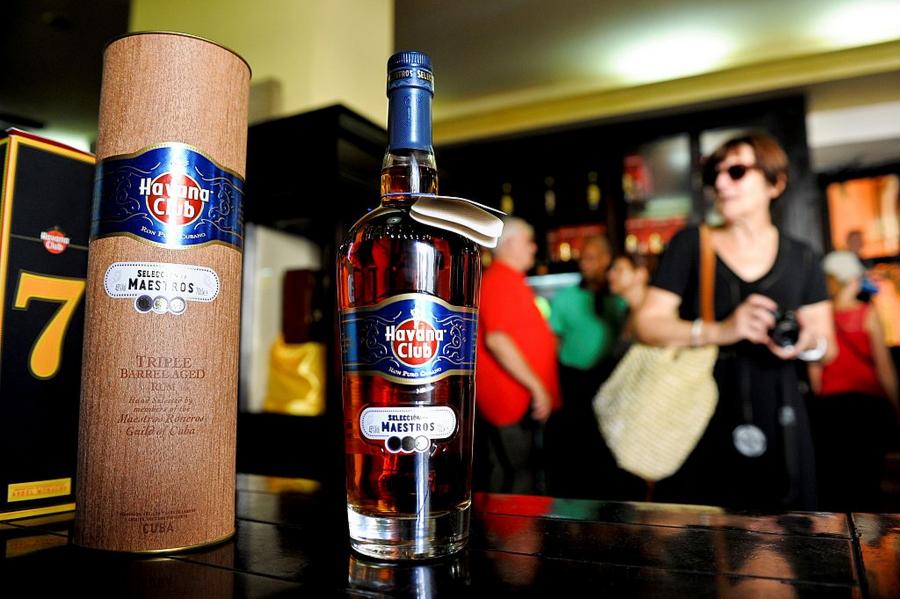 Tourists buy Cuban rum in a store of Havana, on October 18, 2016. US President Barack Obama sought to cement his administration's rapprochement with Cuba, unveiling a new round of loosened trade rules, including lifting limits on rum and cigar imports. / AFP / YAMIL LAGE (Photo credit should read YAMIL LAGE/AFP/Getty Images)
