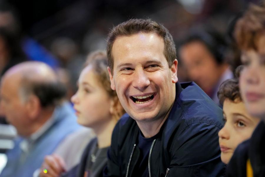 Phoenix Suns owner Mat Ishbia laughing during a game.
