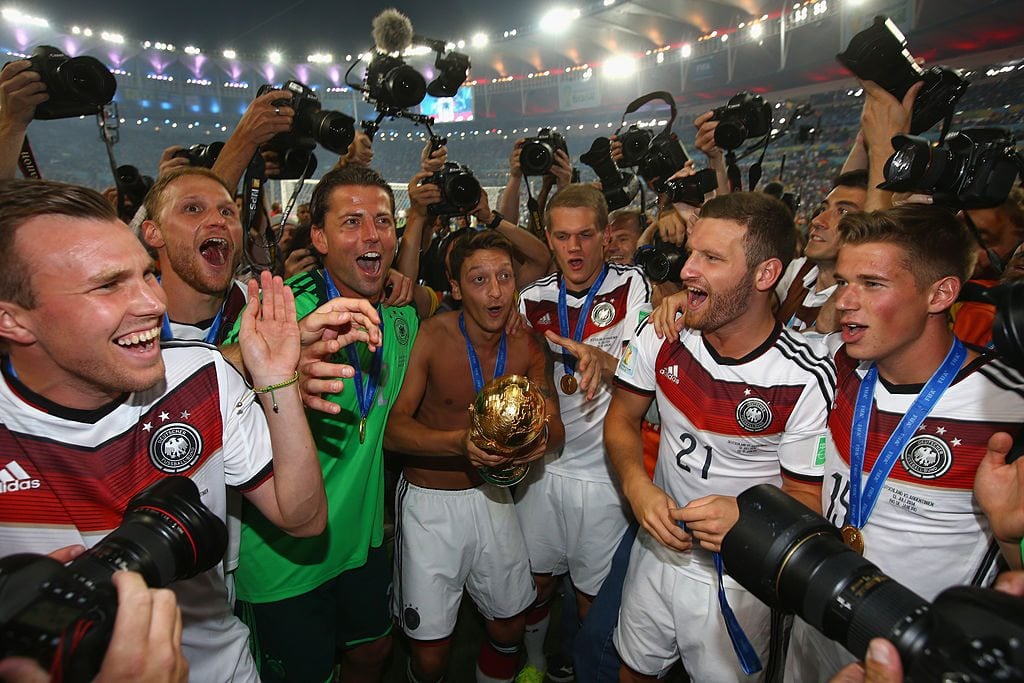 Mesut Ozil of Germany celebrates with the trophy following the