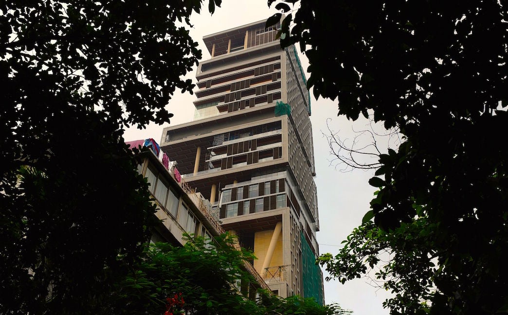 The twenty-seven story Antilia, the newly-built residence of Reliance Industries chairman Mukesh Ambani, is seen in Mumbai on October 19, 2010. The 400,000 square foot residence, named after a mythical island in the Atlantic, is expected to be occupied by Ambani, his wife and three children later in the year. The building has three helicopter pads, underground parking for 160 cars, and requires some 600 staff to run. INDRANIL MUKHERJEE/AFP/Getty Images.